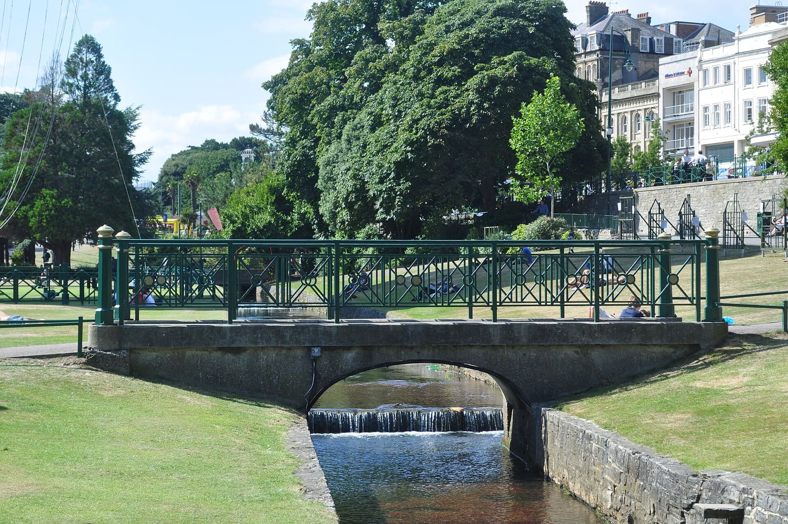 Families walking through Bournemouth's Lower Gardens on a sunny day