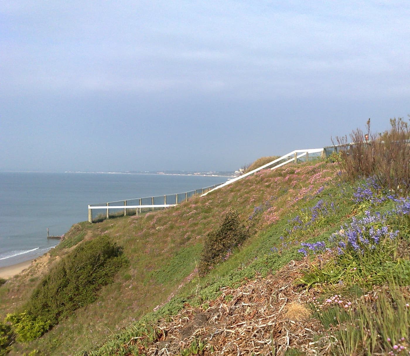 The sandy beach and beach huts below the cliffs at Southbourne